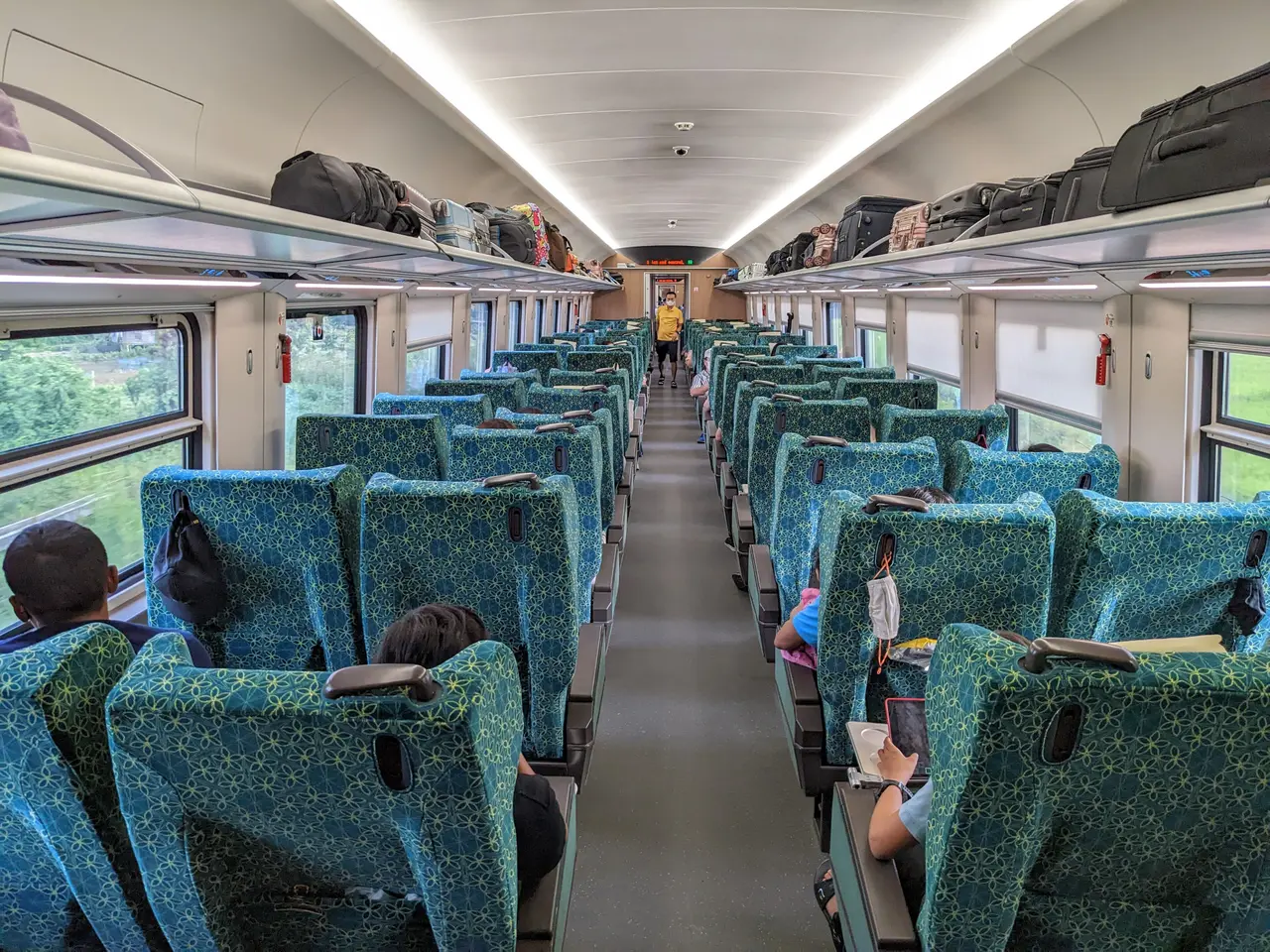 Rows of teal reclining seats in a first-class carriage on the Laos-China Railway