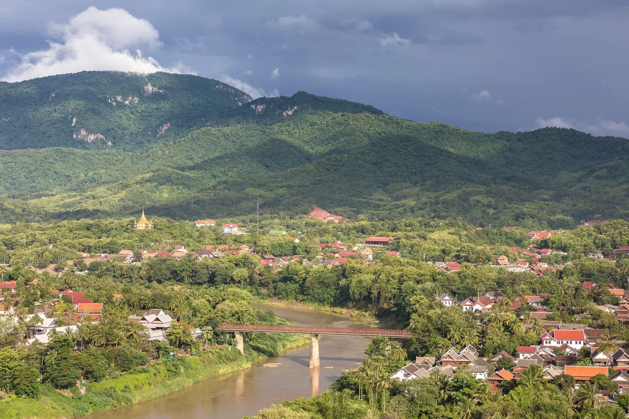 Green hills above Luang Prabang with the old bridge crossing the Nam Khan river below