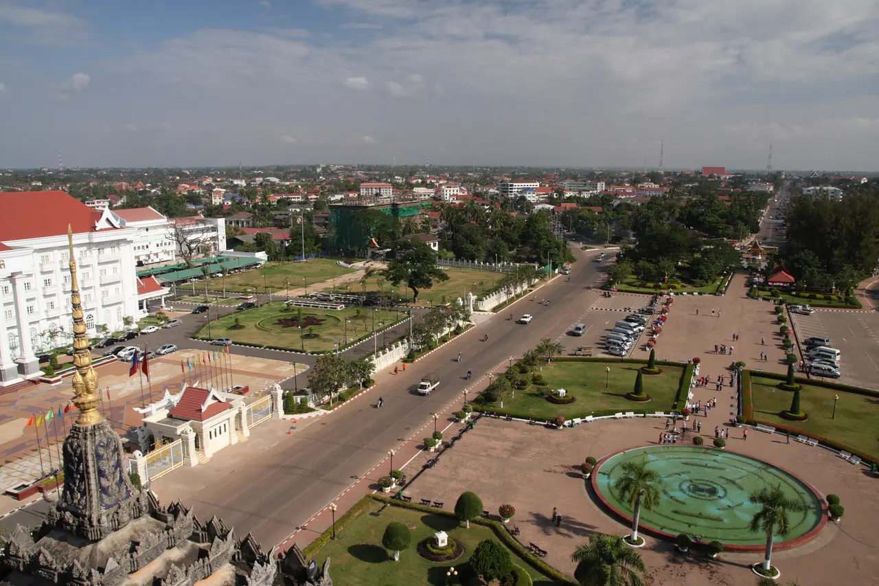 A wide avenue and gardens in central Vientiane seen from the top of the Patuxai monument